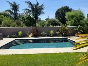Piscine moderne dans jardin paysager ensoleillé