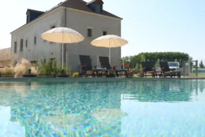 Piscine extérieure devant maison moderne avec transats
