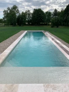 Piscine rectangulaire moderne au milieu d’un jardin verdoyant