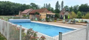 Piscine extérieure avec terrasse en bois et transats